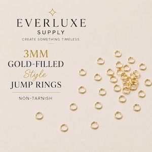 May include: A collection of 3mm gold-filled jump rings scattered on a light surface. The text reads: EVERLUXE SUPPLY, CREATE SOMETHING TIMELESS, 3MM GOLD-FILLED Style JUMP RINGS, NON-TARNISH. These small circular metal connectors are gold in color.