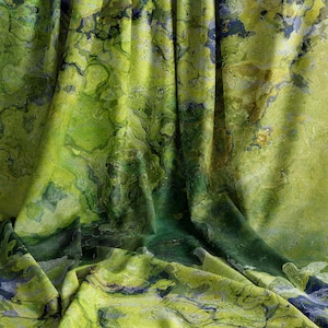 May include: A draped fabric with a marbled pattern in shades of green, yellow, and blue. The fabric has a flowing, organic appearance, with the colors blending and swirling together. The overall effect is reminiscent of a landscape or abstract painting.