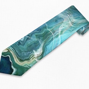 May include: A blue and green tie with a marbled pattern. The tie is made of silk and has a classic design.