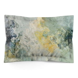 May include: Rectangular pillowcase with an abstract design. The pattern features swirls of gray, yellow, and blue, creating a marbled effect. The pillowcase has a soft, muted color palette, with a light background and darker accents.