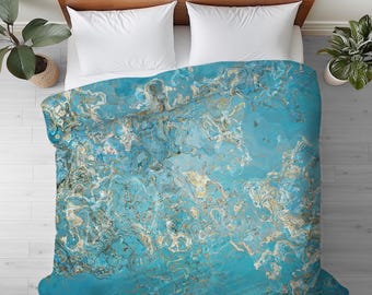 May include: A blue and gold abstract duvet cover with a marbled pattern.
