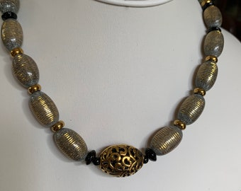 Gold-striped green necklace with rhyolite and brass