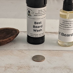 May include: Two bottles of beard care products, one labelled "Best Beard Wash" and the other labelled "Best Beard Oil". Both bottles are white with black text and feature the company name "Carden Farms" and contact information. The bottles are sitting on a white wooden surface.