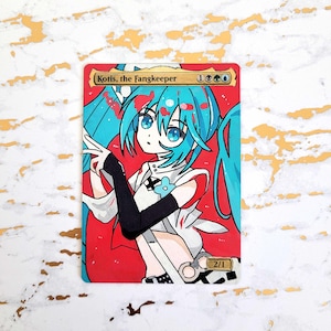 May include: A custom trading card with an anime-style illustration of a character with turquoise hair and eyes. The card reads "Kotis, the Fangkeeper" and includes game symbols. The background is red, and the character wears a white and black outfit.