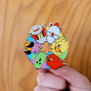 May include: A colourful enamel pin featuring a variety of cartoon characters, including a flower, a cactus, a bird, and a creature with a crown. The pin is designed in a circular shape with a multi-coloured background.