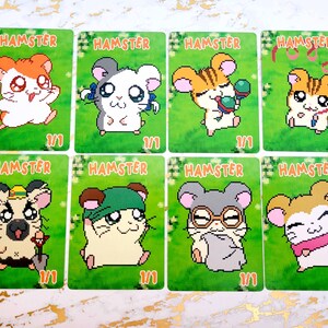 May include: Eight trading cards with cartoon hamsters on a green background. Each card has the word "HAMSTER" at the top and a unique hamster illustration. The cards are numbered "1/1".