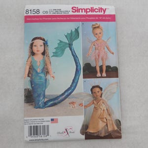 May include: Simplicity pattern 8158 for doll clothes. The pattern features designs for a mermaid, a fairy in a pink dress, and a fairy in a gold dress. The pattern is for 18-inch dolls.