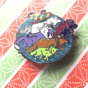 May include: A colorful enamel pin featuring a group of seven dogs in various poses, surrounded by blue and white waves. The dogs are purple, brown, green, white, red, and blue.