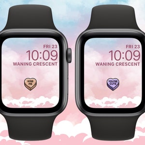 May include: Two Apple Watch faces with a pink and blue watercolor background. The time is 10:09 and the date is FRI 23. The moon phase is Waning Crescent. One watch face has a pink candy heart with the text "KISS ME" and the other watch face has a purple candy heart with the text "YOU'RE CUTE".