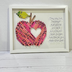 May include: A framed artwork featuring a red apple made of crayons with a heart-shaped cutout. The text "they may not remember everything you said. but they will never forget how special you made them feel." is printed on the white background.