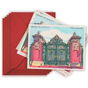 May include: A stack of red envelopes with a white card featuring a hand-drawn illustration of the entrance to Brown University in Providence, Rhode Island. The card reads "Brown University" and "Providence".