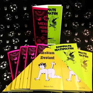 May include: A collection of small, colorful paperbacks with black and white illustrations. The books are titled "Mexican Horror Stories", "Roommate Deathmatch", "Medium Deviant", and "Roommate Match".