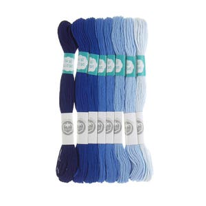 May include: A set of 10 embroidery floss skeins in shades of blue, from dark navy to light blue. Each skein is labeled with the brand name "OTTON" and the percentage of cotton, "100%".