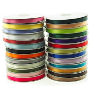 May include: Two stacks of colorful satin ribbon spools. The ribbons are in various colors, including pink, yellow, white, red, and black. The spools are on a white background. Each spool appears to be approximately 1 inch in diameter.