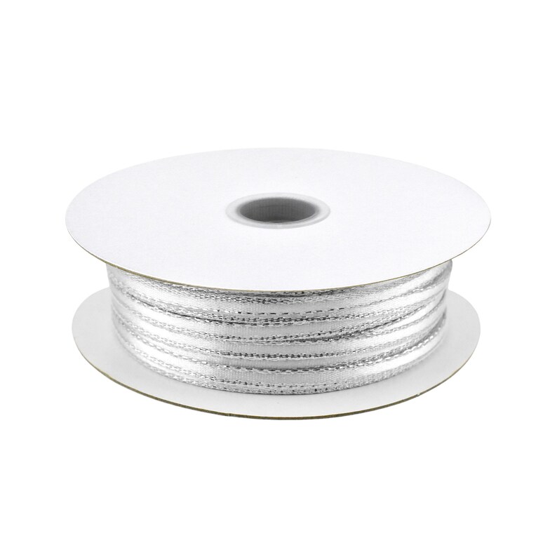 May include: A spool of white satin ribbon with silver thread accents.