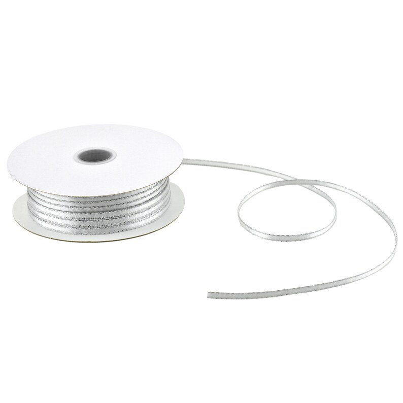 May include: A spool of silver ribbon with a white core. The ribbon is thin and has a subtle shimmer.