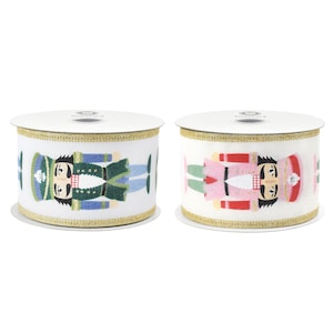May include: Two spools of white ribbon with a gold trim. Each spool features a repeating pattern of a nutcracker soldier in either green and blue or pink and red. The spools are on a white surface.