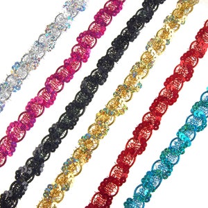 May include: A collection of decorative sequin trim in various colors, including silver, pink, black, gold, red, and turquoise. Each trim features a scalloped edge and is adorned with shimmering sequins, ideal for embellishing clothing or craft projects.