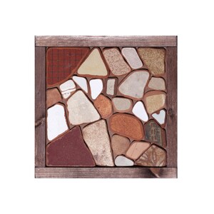 May include: Square mosaic tile art with a wooden frame. The mosaic features irregularly shaped pieces in shades of beige, brown, white, and red. The wooden frame is a dark brown color.
