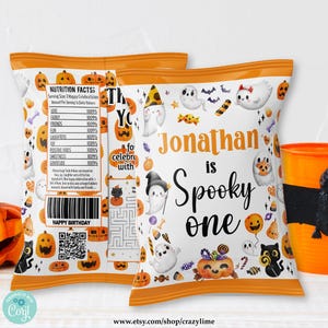 May include: Two Halloween-themed chip bags with orange and white designs, featuring pumpkins, ghosts, and the text "Jonathan is Spooky one." An orange cup with a black bat decoration is also visible.