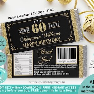 May include: A black and gold chocolate bar wrapper with a gold glitter design. The wrapper says "Cheers to 60 Years" and "Benjamin Williams Happy Birthday". The back of the wrapper has a thank you message and a barcode.