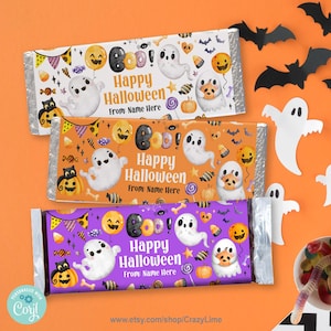 May include: Three Halloween-themed candy bar wrappers with ghost and pumpkin illustrations. Each wrapper has the text "Happy Halloween" and space for a name. The wrappers are white, orange, and purple, with decorative bats and ghosts.