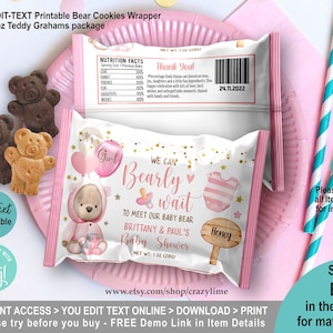 May include: Printable bear cookie wrapper with pink and gold design. The wrapper features a teddy bear wearing a pink outfit and holding a book. The text on the wrapper reads "It's a Girl! We can Bearly wait to meet our baby bear. Brittany & Paul's Baby Shower".