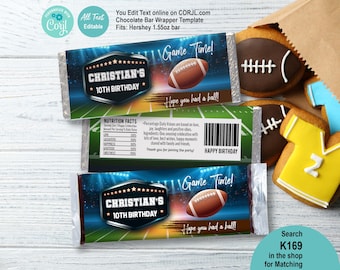 May include: Chocolate bar wrappers with a football theme, featuring the text "CHRISTIAN'S 10TH BIRTHDAY" and "Game Time!" The wrappers are designed with a football field and stadium lights background. Also shown are football-shaped cookies and a yellow jersey cookie.