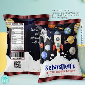 May include: A printable chip bag wrapper with a space theme. The wrapper features a rocket ship, planets, and stars. The text on the wrapper says "Sebastien's 1st Trip Around the Sun!" and includes a nutrition facts label and a QR code.