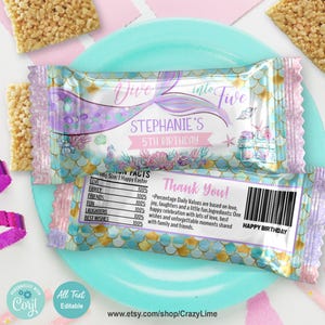 May include: A mermaid-themed birthday party favour wrapper with a blue, green, and gold scale pattern. The wrapper says "Dive into Five Stephanie's 5th Birthday" and includes a list of "Happy Easter Facts" with a 100% rating for love, family, friends, fun, laughters, and best wishes. The wrapper also says "Thank You!" and "Happy Birthday".