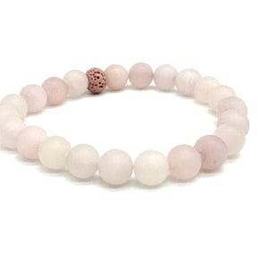 May include: A pink and white beaded bracelet with a brown lava bead. The bracelet is made of frosted glass beads.
