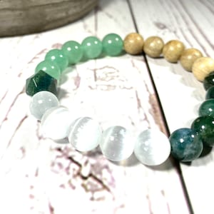 May include: A green, white and brown beaded bracelet with a mix of round and faceted beads.