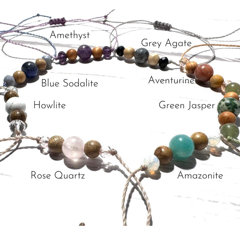 May include: A bracelet made with various gemstones, including amethyst, grey agate, blue sodalite, howlite, aventurine, green jasper, rose quartz, amazonite, and wooden beads.