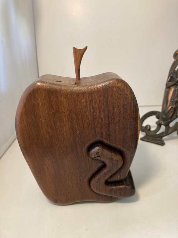 A large hand-carved apple-shaped wooden box with a secret puzzle opening — the 29 favorites say people genuinely stop and want this.