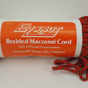May include: A roll of red and green braided macrame cord, labeled "EZKNOT Braided Macrame Cord 100% Texturized Polypropylene 3/16mm-50 Yards (45.7 Meters)"