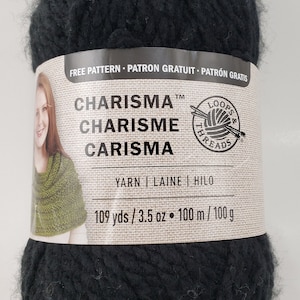 Puede incluir: Una madeja de hilo negro llamada "Charisma" de Loops & Threads. La etiqueta dice "Patrón gratuito - Patron Gratuit - Patrón Gratis" y "Yarn | Laine | Hilo". También dice "109 yds / 3.5 oz • 100 m / 100 g".