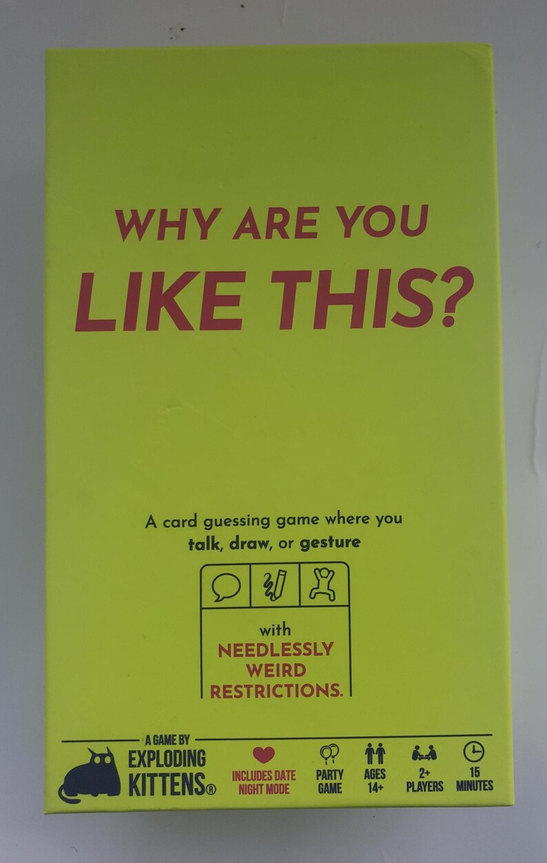 May include: A bright yellow card game box with the text "WHY ARE YOU LIKE THIS?" in red. The box says it's a card guessing game where you talk, draw, or gesture. It's made by Exploding Kittens and includes "NEEDLESSLY WEIRD RESTRICTIONS."