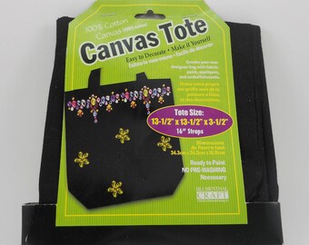 May include: Black canvas tote bag with a green and yellow border. The tote bag is 13 1/2 inches by 13 1/2 inches and has 16 inch straps. The tote bag is ready to paint and has no pre-washing necessary.