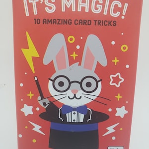 May include: A red box with the text "IT'S MAGIC!" and "10 AMAZING CARD TRICKS." The box features a cartoon rabbit wearing a tuxedo and top hat. The box is for ages 6+.