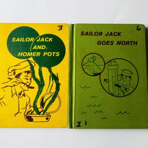May include: Two vintage children's books, "Sailor Jack and Homer Pots" and "Sailor Jack Goes North." The first book has a yellow cover with a green design and illustration. The second book has a green cover with a brown illustration.