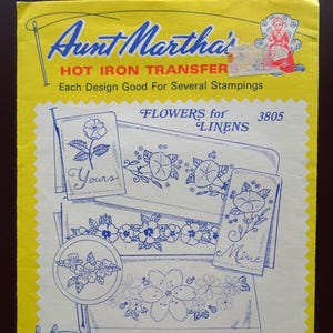 May include: A vintage Aunt Martha's Hot Iron Transfer packet. The yellow cover features blue text and illustrations of floral designs for linens. The packet includes designs for embroidery, textile painting, needlepoint, and other art crafts. The text "Yours" and "Mine" are visible.
