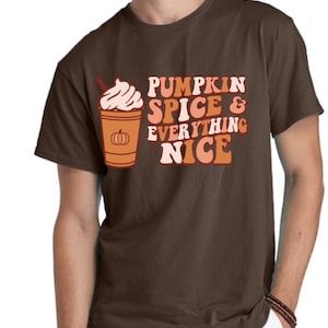 May include: A brown t-shirt with a graphic of a pumpkin spice latte and the text "Pumpkin Spice & Everything Nice".
