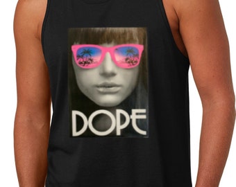 May include: A black tank top with a graphic print of a woman wearing pink sunglasses with palm trees reflected in the lenses. The word "DOPE" is printed below the woman's face.