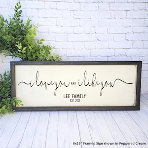 May include: A framed sign with the text "i love you and i like you" in black cursive script. Below the text is "LEE FAMILY EST. 2021". The sign is 6x16 inches and is shown in Peppered Cream.