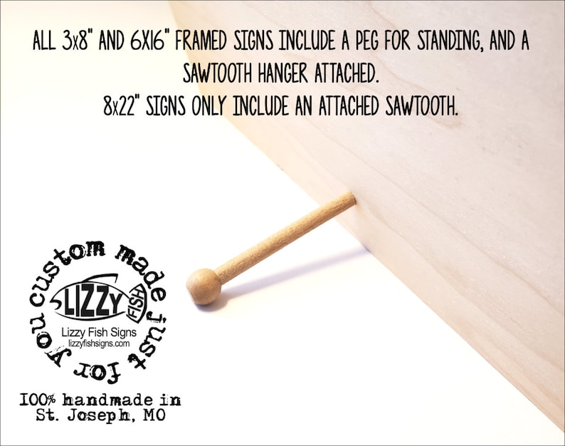 May include: A close-up of a wooden sign with a peg for standing. The sign is made of light wood and has a natural finish. The text on the sign reads "ALL 3x8" AND 6X16" FRAMED SIGNS INCLUDE A PEG FOR STANDING, AND A SAWTOOTH HANGER ATTACHED. 8x22" SIGNS ONLY INCLUDE AN ATTACHED SAWTOOTH."