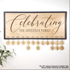 May include: Wooden family celebration sign with the text "Celebrating THE ANDERSON FAMILY". The sign has a black frame and includes a series of round wooden disks hanging below, each with a name and date. The sign is 10 x 24 inches.
