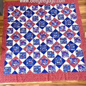 May include: A blue and white quilt with a red border. The quilt is made up of squares with a pattern of footballs and the word "Bills".