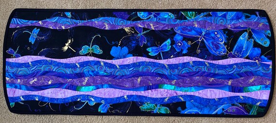 43 by 17 inches. Reversible table runner