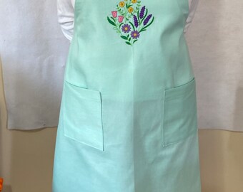 A beautiful and durable apron with decorative appliqué on the bib.