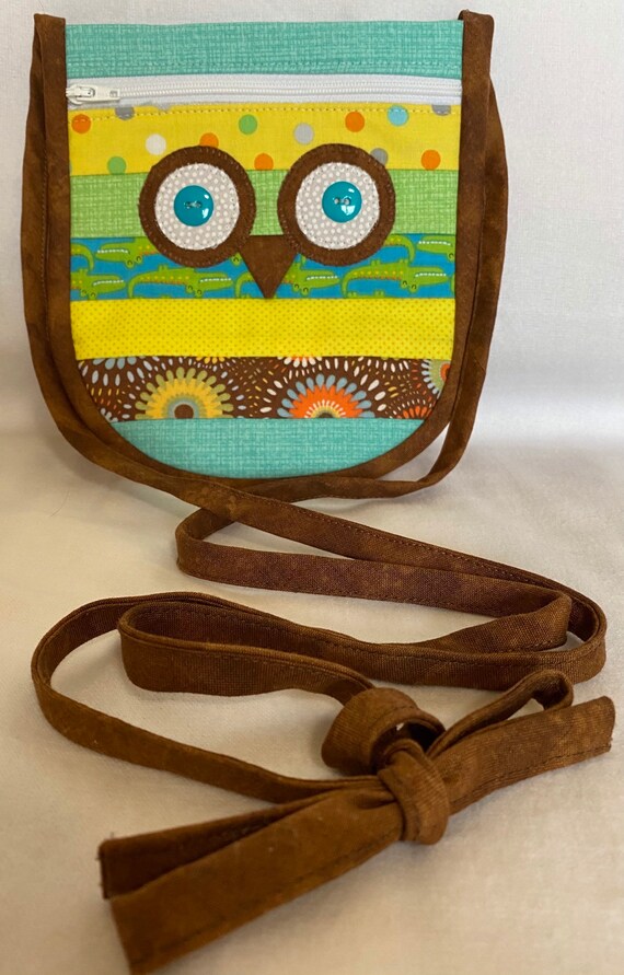Owl sling/messenger bag 7 by 7 inches, zippered pocket and 25 inch strap that can be adjusted